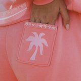 matching coral pink set, with pink palm puff pattern border